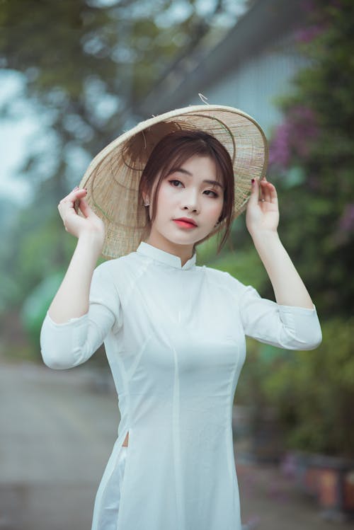 A Woman wearing Dress and Hat