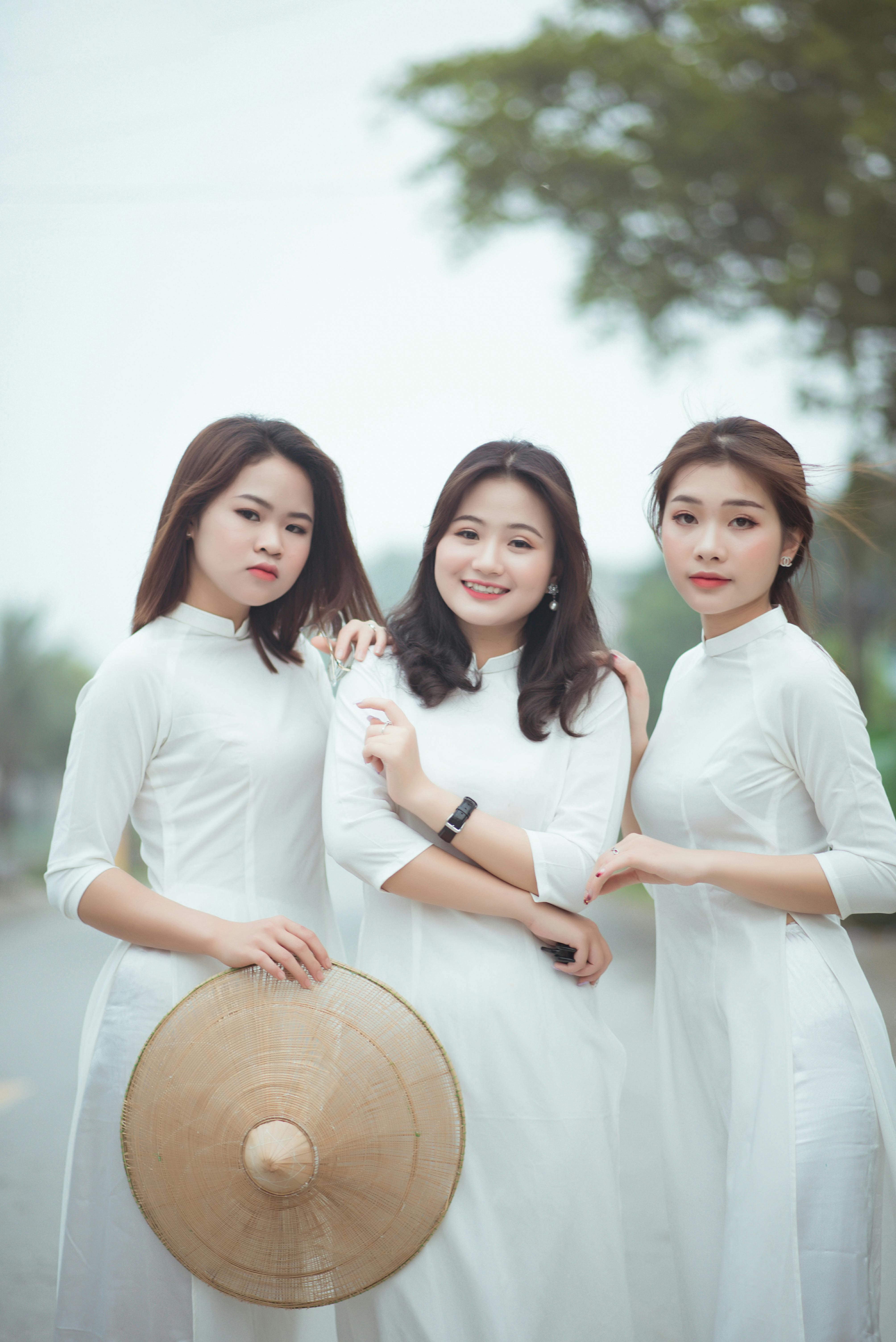 Three Beautiful Women in White Dresses Looking at the Camera  Free Stock  Photo