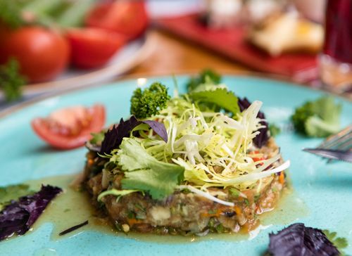 Free Close-up of a vibrant vegan salad with fresh greens and garnish on a plate. Stock Photo