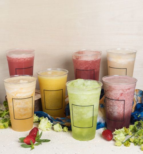 Colourful fruit coolers in clear cups on a pale backdrop — photo by Farhad Ibrahimzade on Pexels