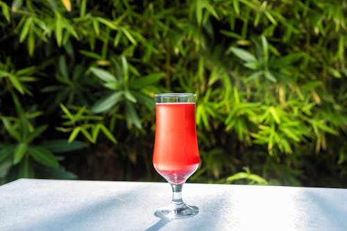 A Red tropical Drink in Champagne Glass