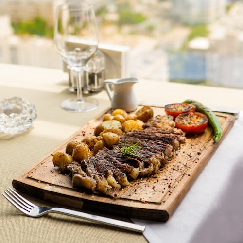 Rib Eye Steak on a Wooden Board 