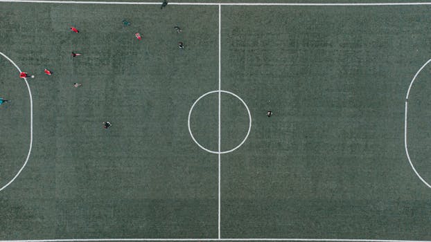 Drone view of a soccer match in Lviv, Ukraine, capturing players in action from above.