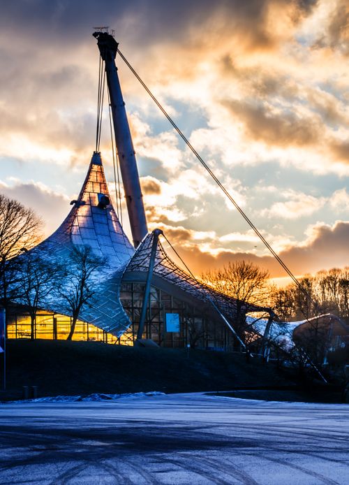 Free The iconic Olympiapark structure in Munich captured at dusk with vibrant clouds. Stock Photo