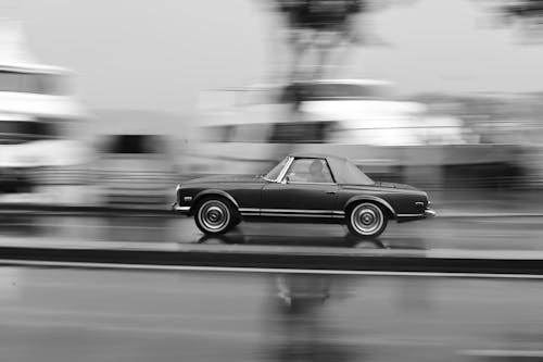 Free Grayscale Photo of Car on Road Stock Photo