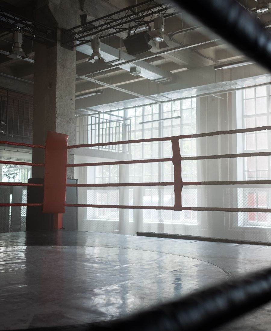 Empty boxing ring in a light-filled gym