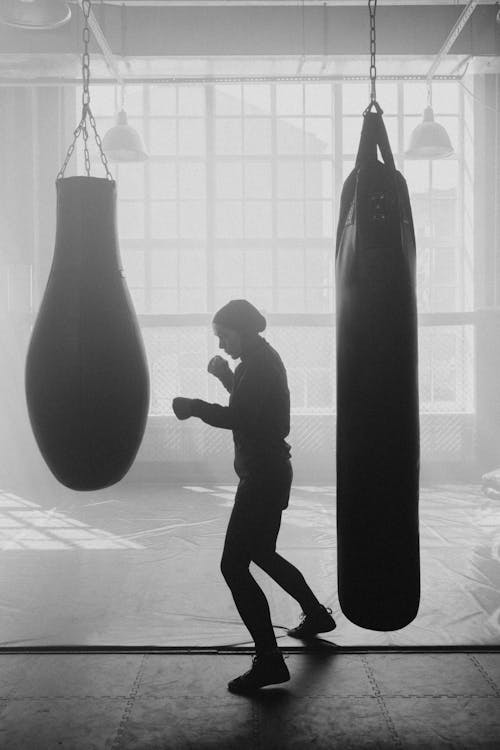 Free Grayscale Photography of Person in Boxing Gym Stock Photo