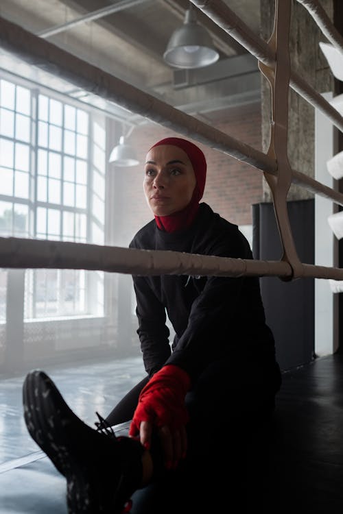 Woman Sitting on Boxing Ring