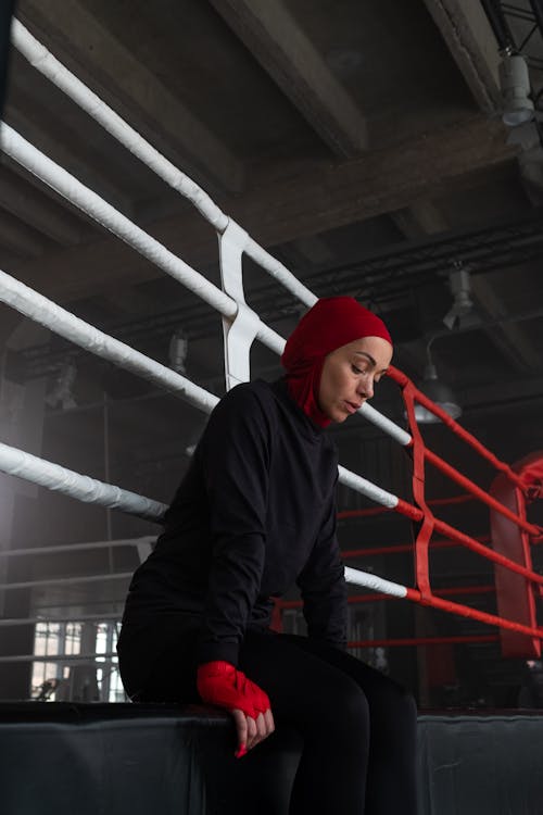 A Woman Sitting on a Boxing Ring