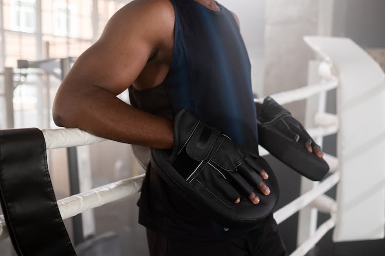 Man In Blue Tank Top Wearing Boxing Pads