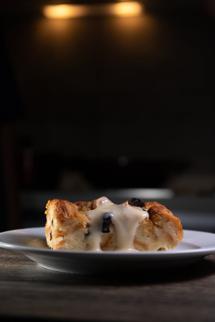 Bread Pudding With Cream On White Ceramic Plate