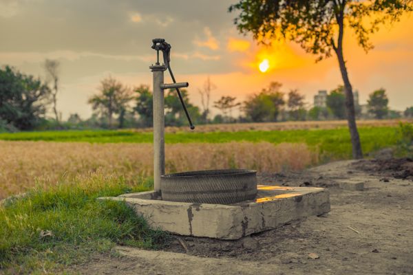 A vintage hand water pump on a homestead