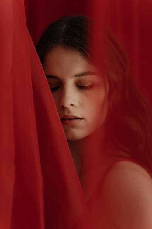 Portrait of Woman Among Red Curtains 