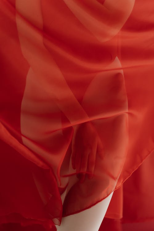Free Body of a Woman Covered with Red Sheer Fabric Stock Photo