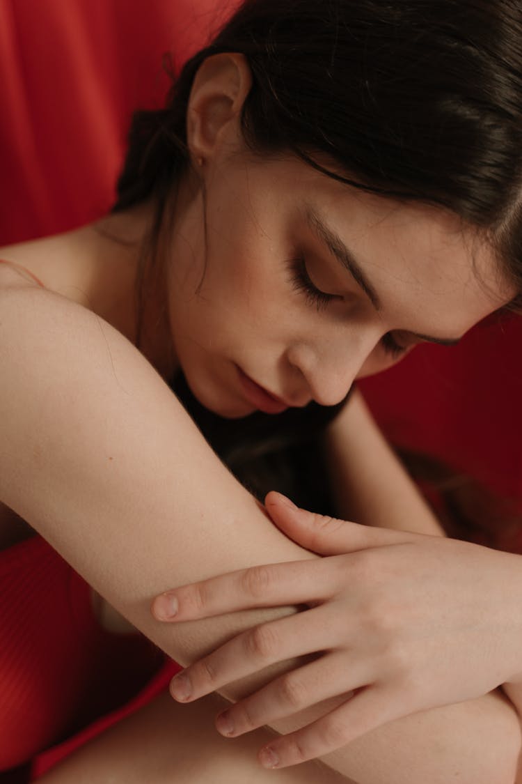 Close-Up Shot Of A Pretty Woman Touching Her Skin