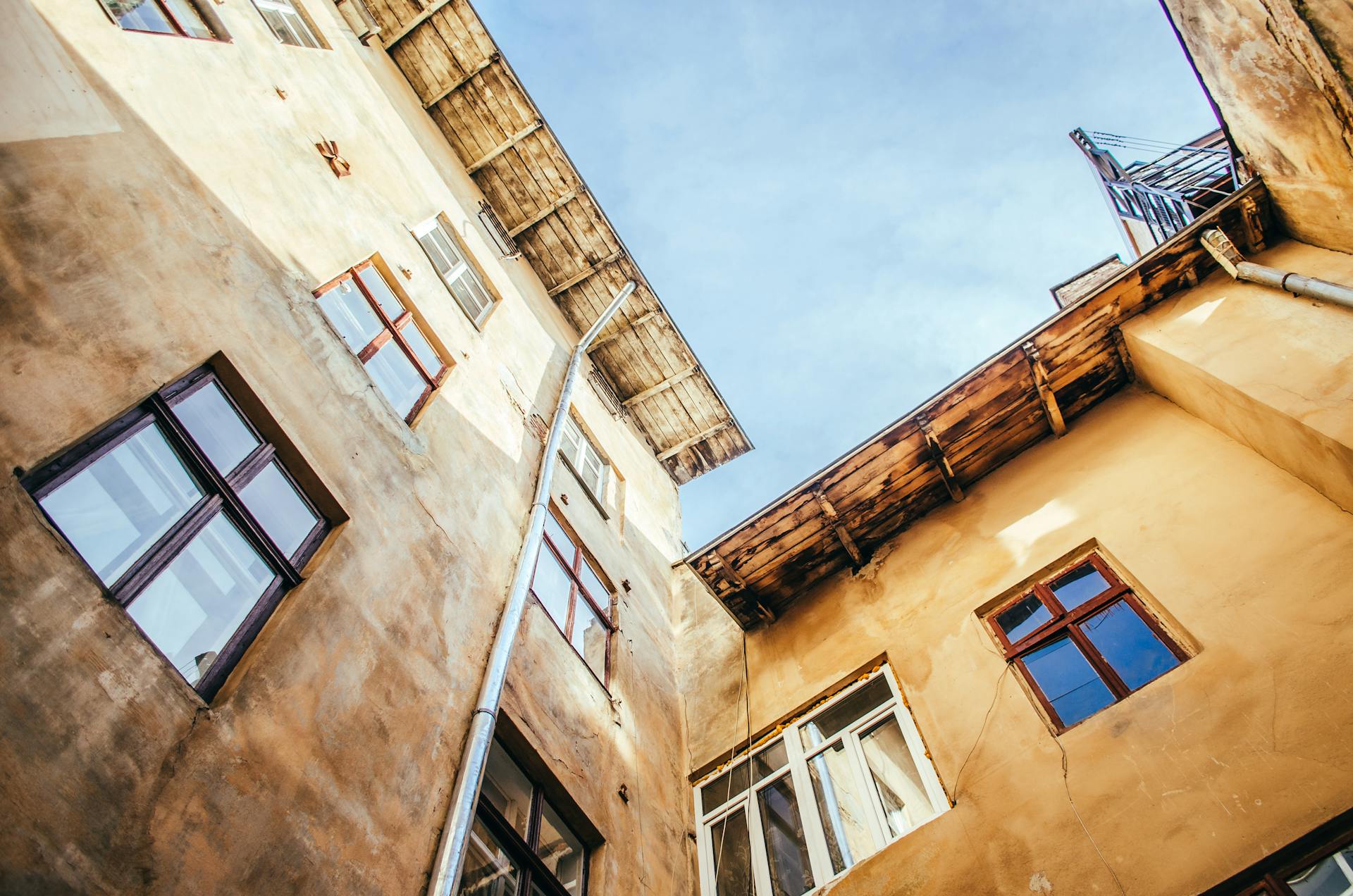 Low angle view of rustic building exteriors in Lviv, highlighting unique regional architecture under clear skies.