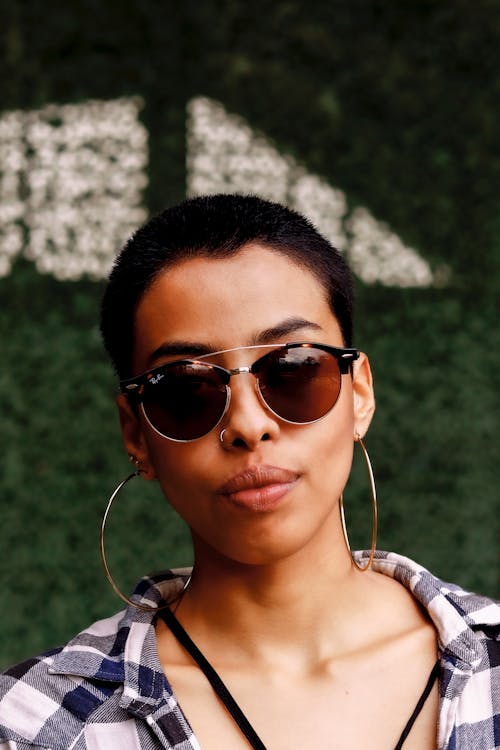 Close-Up Shot of a Short-Haired Woman Wearing Sunglasses