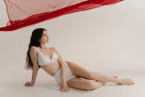 Woman in White Bikini Sitting on the Floor