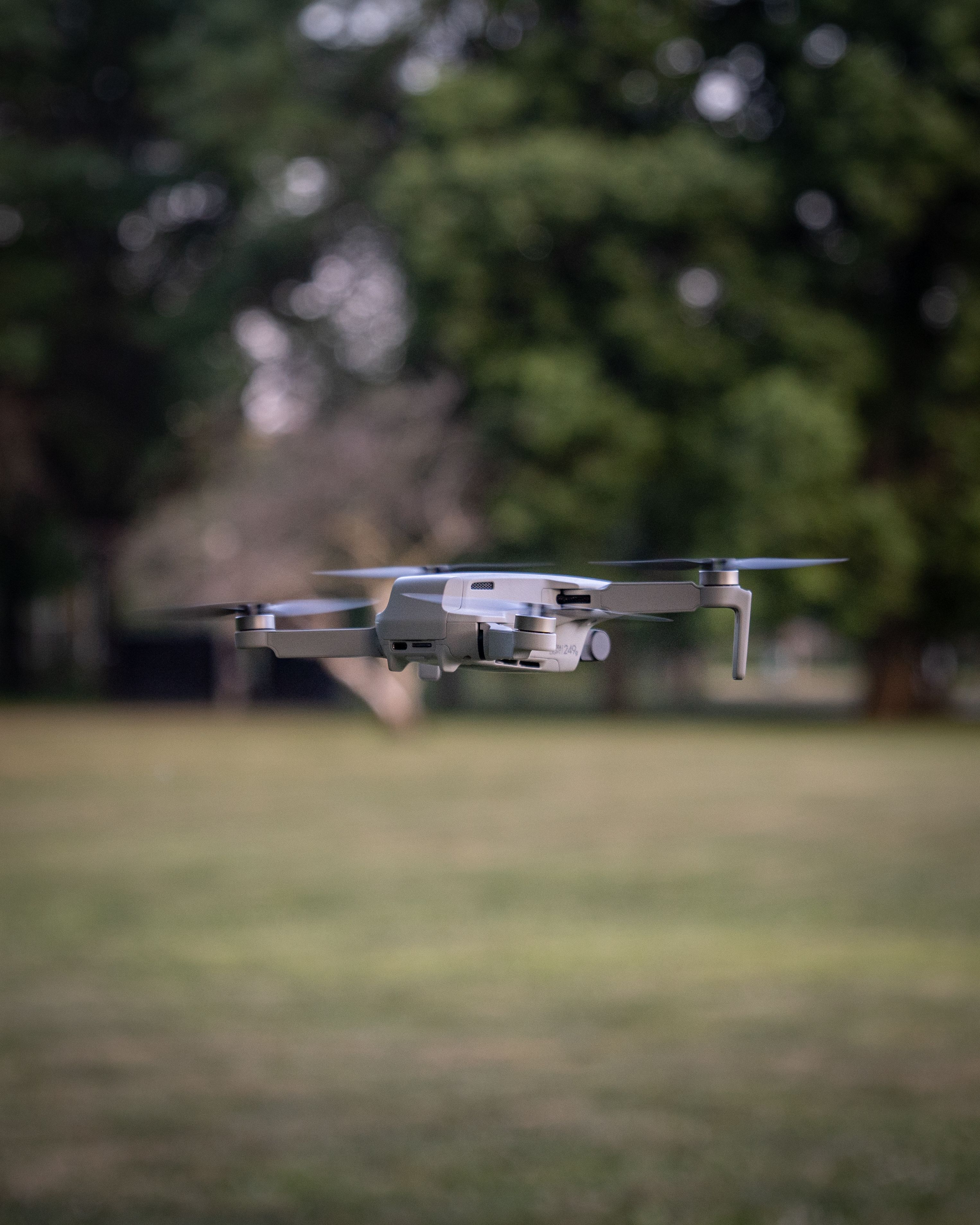 Flying Camera Close-Up Photography of a Gray Drone Camera Flying · Free Stock Photo