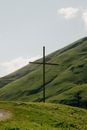 Gray Cross on Green Grass Field