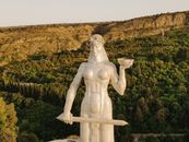 White Angel Statue Near Green Trees