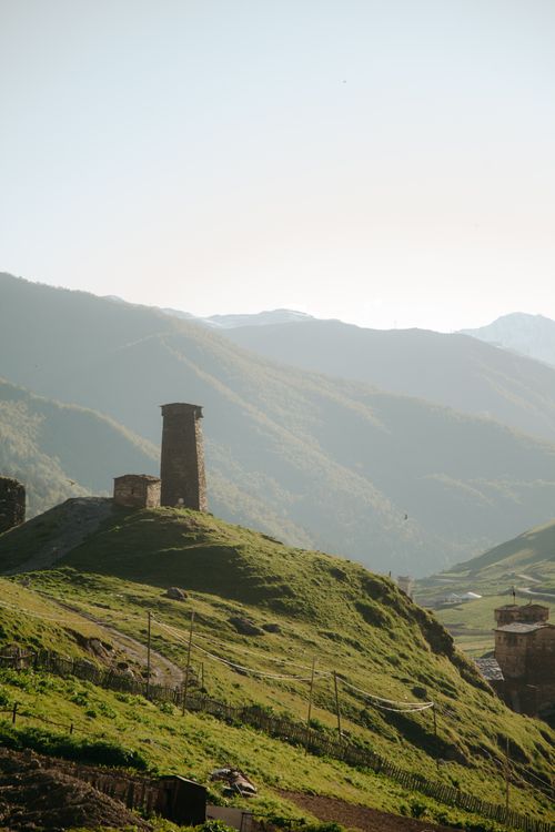 Free A tall ancient tower on a hilltop in a remote and scenic mountain valley. Stock Photo