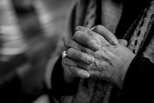 Grayscale Photography of Person in Praying Hands
