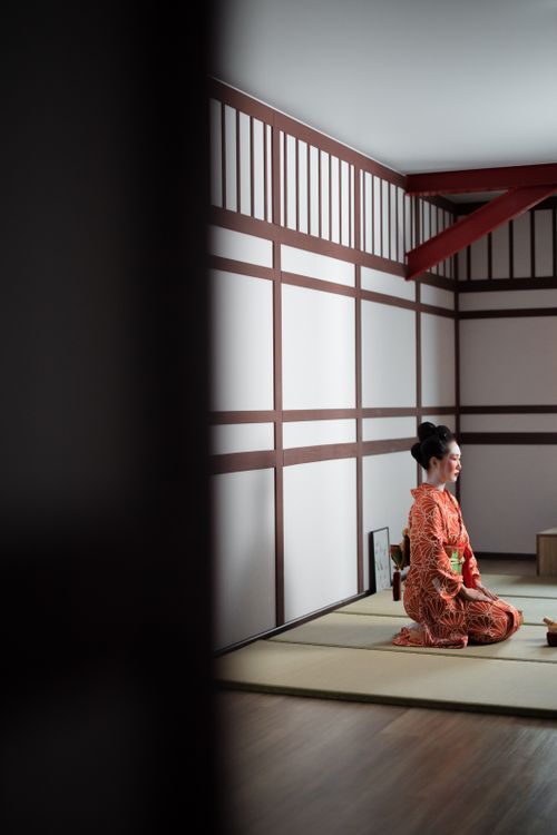 Free Asian woman in traditional kimono kneeling in a traditional tea room. Stock Photo