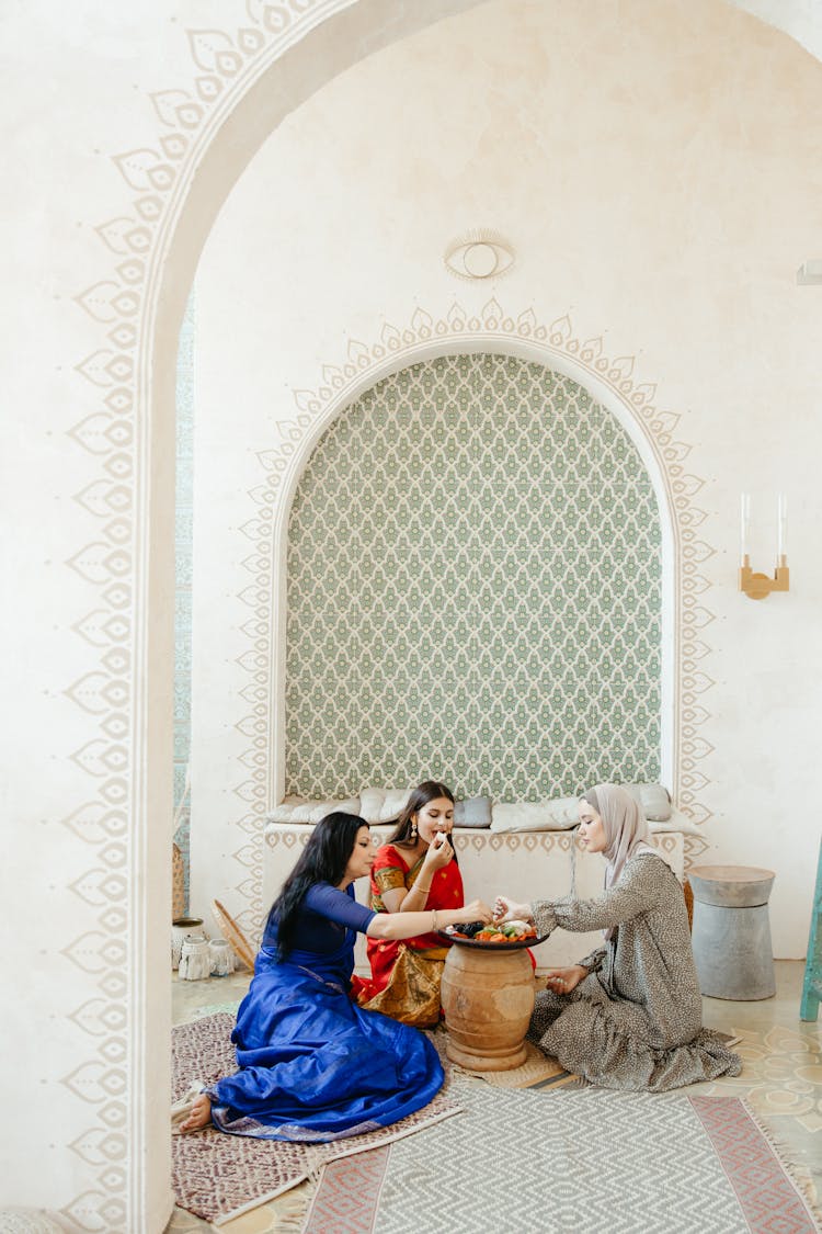 Muslim Women Eating Dinner In Home