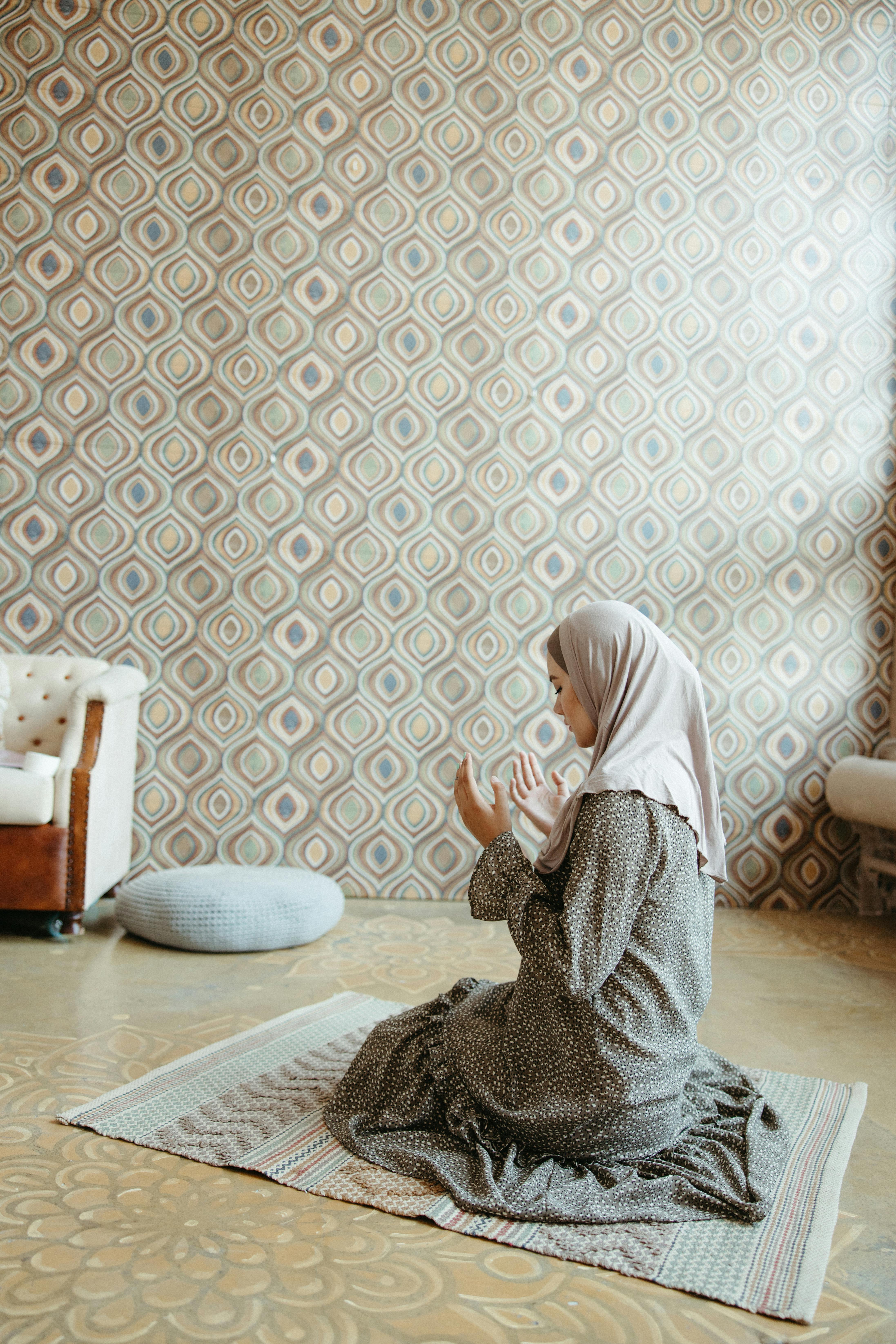 woman in white hijab sitting on floor