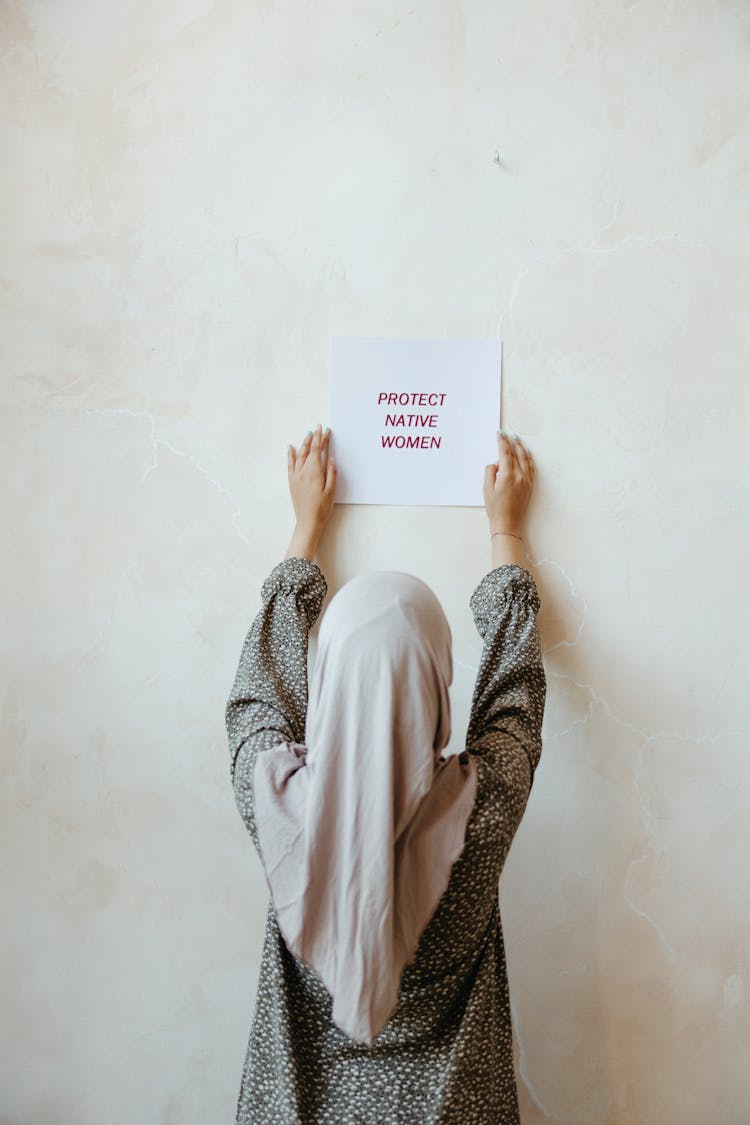 A Woman Holding A Poster