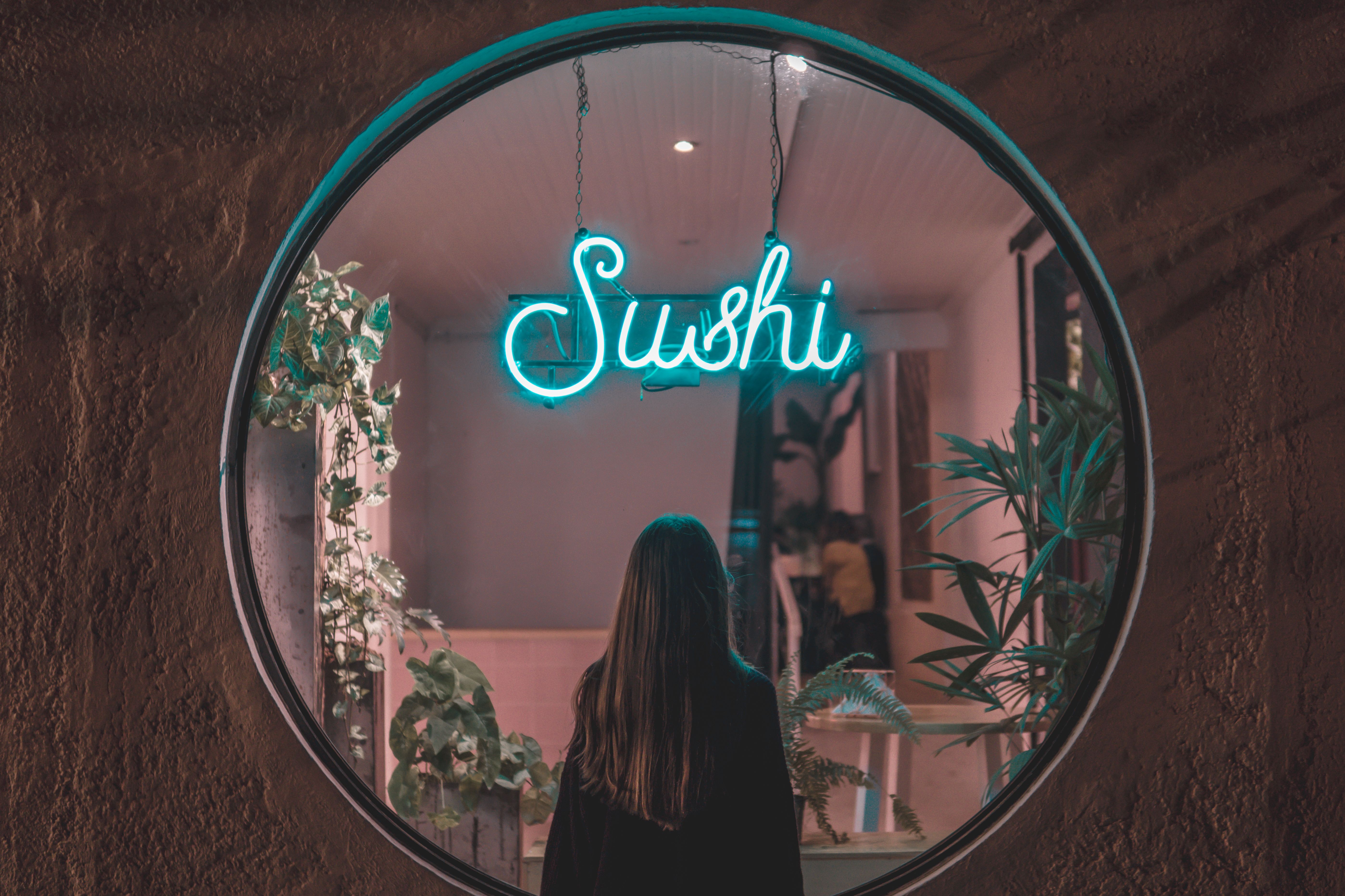 Woman Standing in Front of a Neon Signage · Free Stock Photo