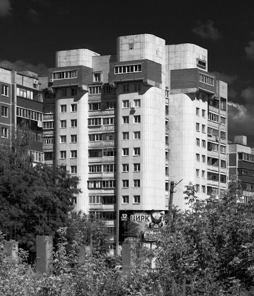 Grayscale Photo of High Rise Concrete Building