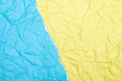 Close-Up Shot of Blue and Yellow Paper