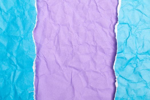 Vibrant torn blue and purple paper texture with artistic composition.
