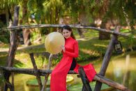 Girl in Red Long Sleeve Dress Holding Yellow Round Fruit