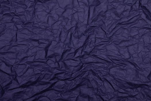 Dark blue textured wrinkled paper surface ideal for backgrounds or creative projects.