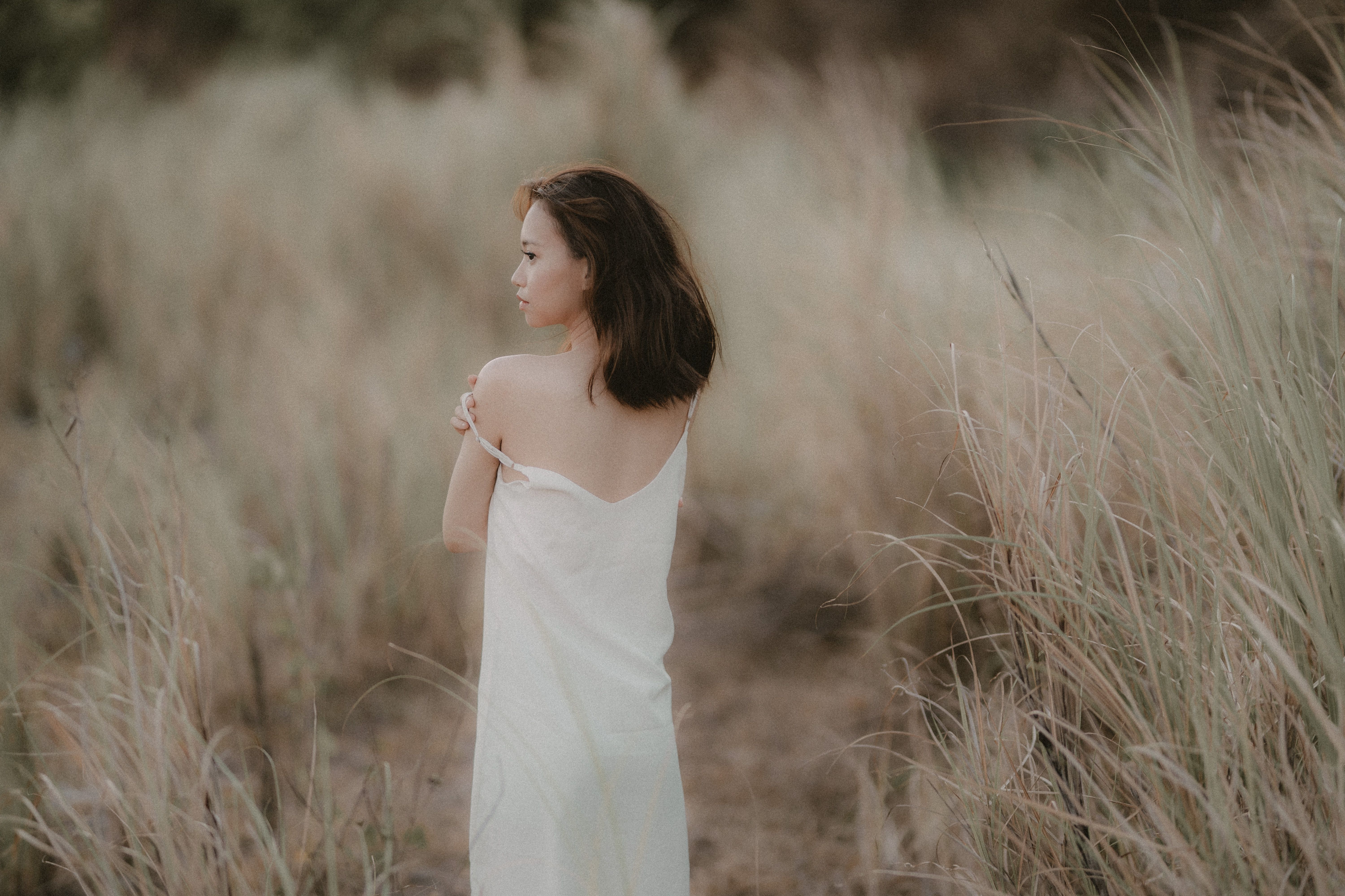Woman in White Dress Standing on Brown Grass Field · Free Stock Photo