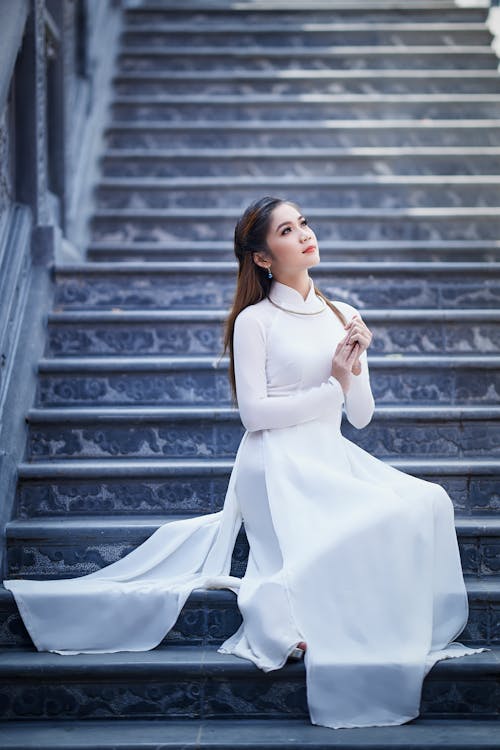 Bride in White Dress Sitting on Stairs