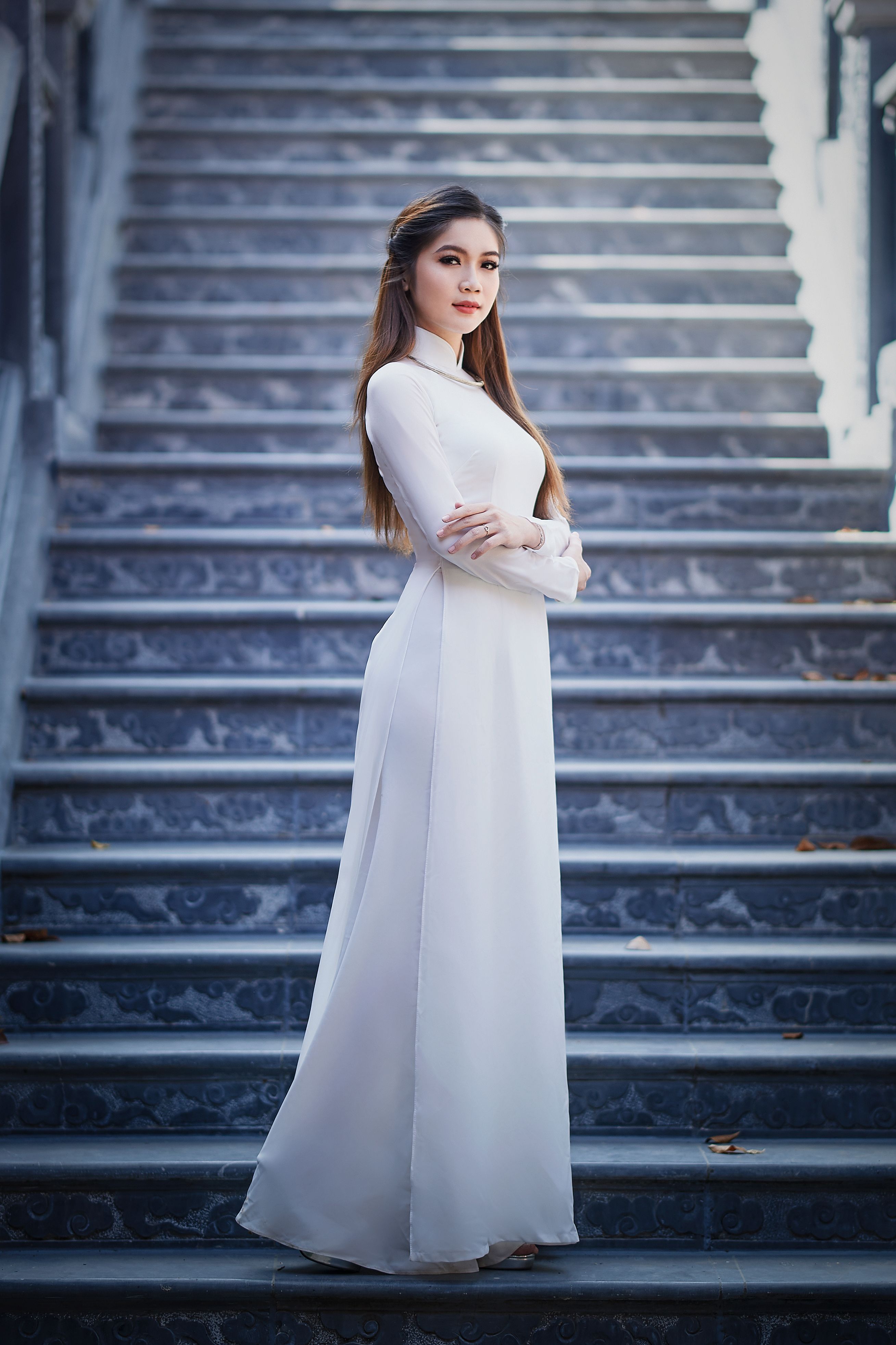 A Woman in White Long Sleeve Dress Standing on the Stairs · Free Stock ...