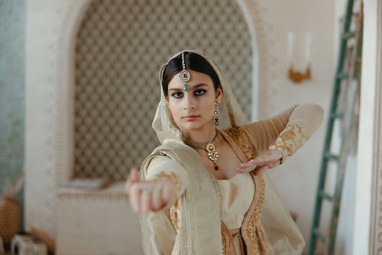 Young Indian Woman In Traditional Clothes Dancing