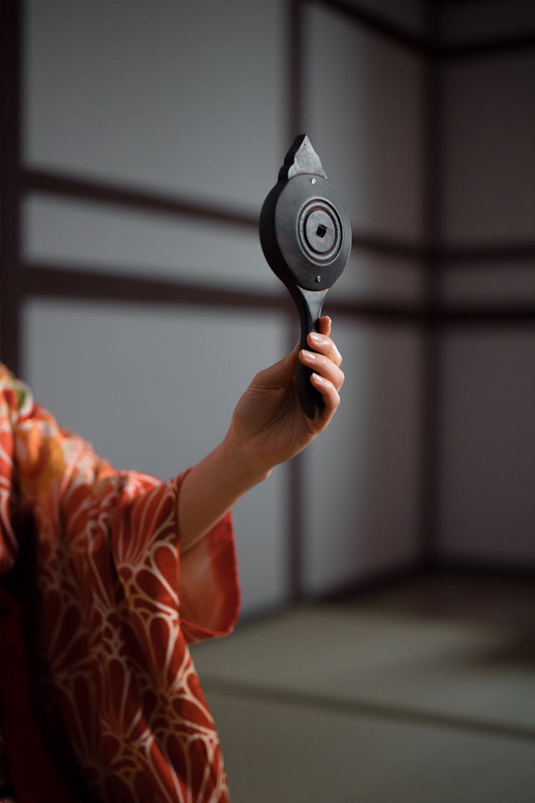 Person Holding A Wooden Hand Mirror