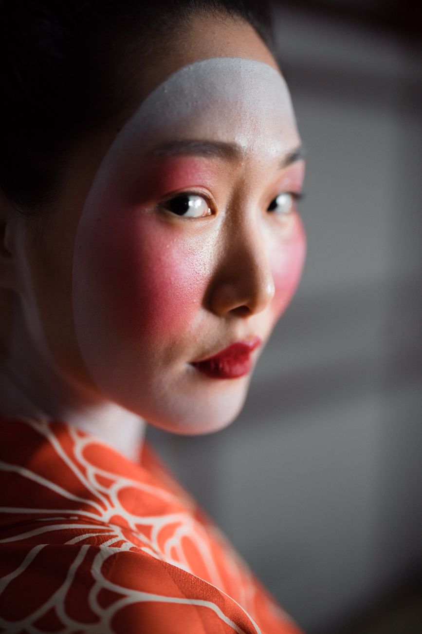 Elegant portrait of a geisha in vibrant kimono, showcasing traditional Japanese culture and beauty.