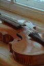 Brown Violin on Brown Wooden Table