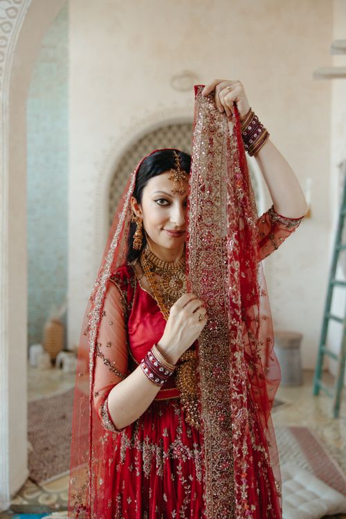 Woman in Red Traditional Dress Standing Beside a Wall · Free Stock Photo
