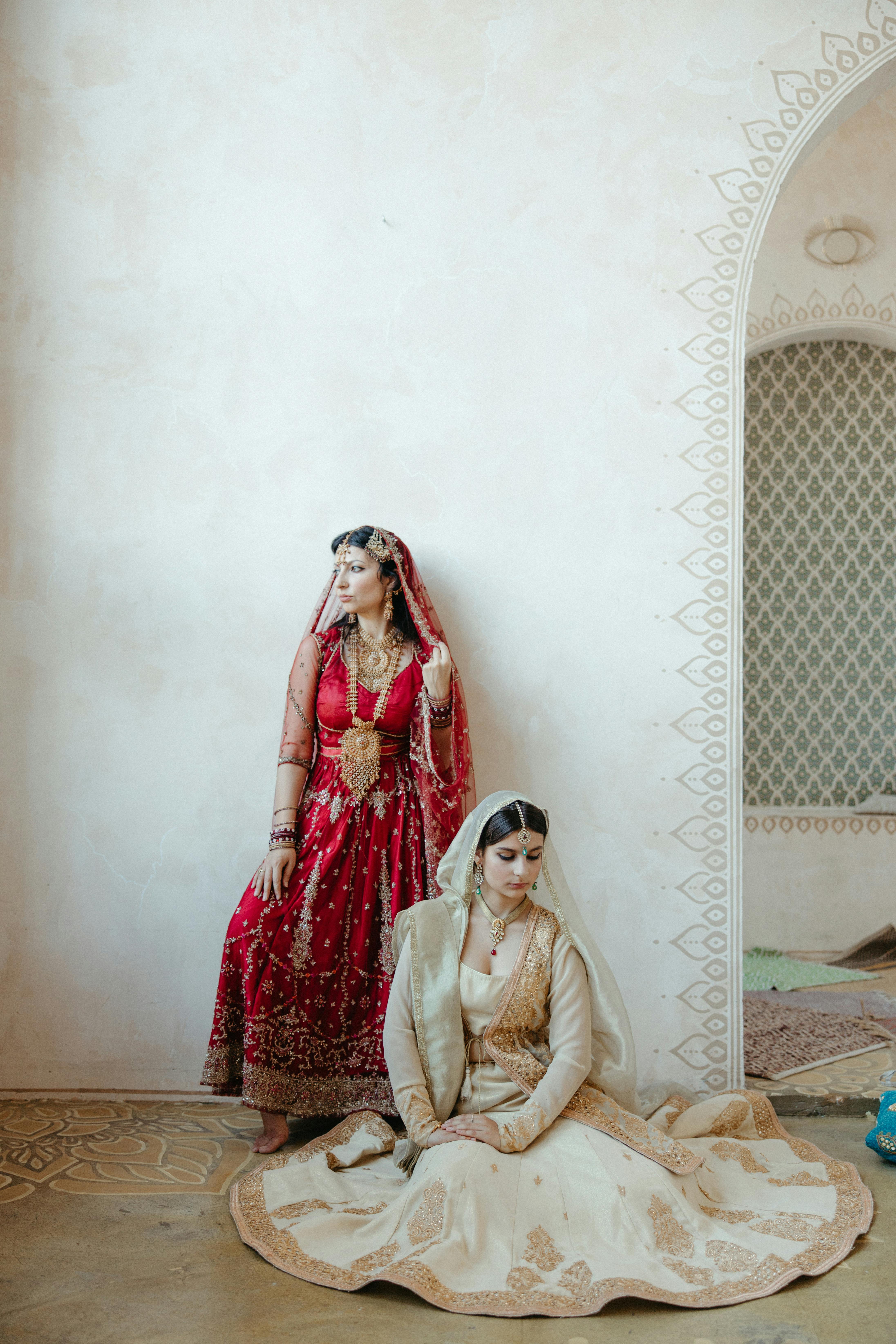 beautiful women posing together wearing sari