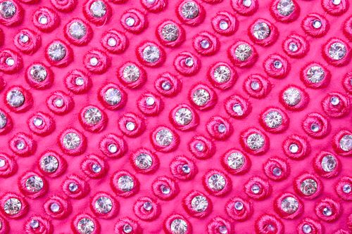 Free Close-up of vibrant pink fabric adorned with sparkling diamonds for a luxurious design. Stock Photo