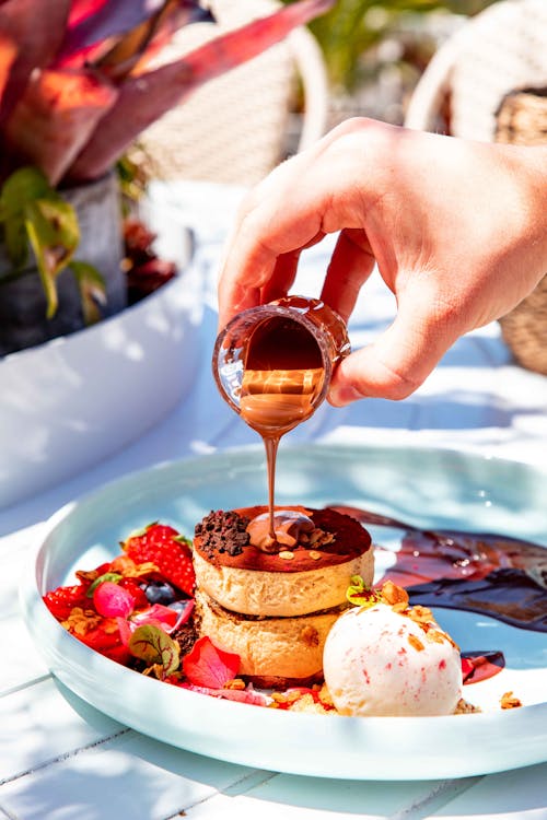 Free Person Pouring Chocolate on the Pancake Stock Photo