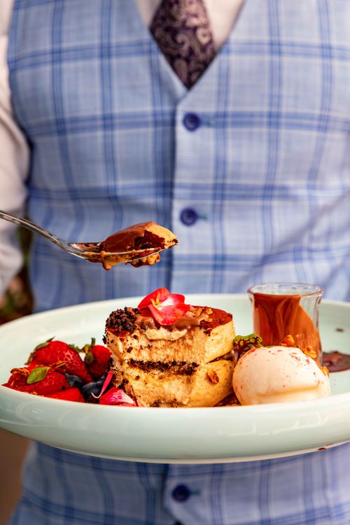 Free Decadent chocolate cake with berries and ice cream elegantly served on a plate. Stock Photo
