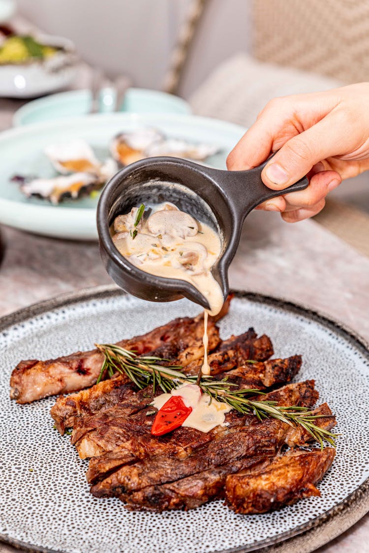 Pouring Mushroom Gravy On Ribs